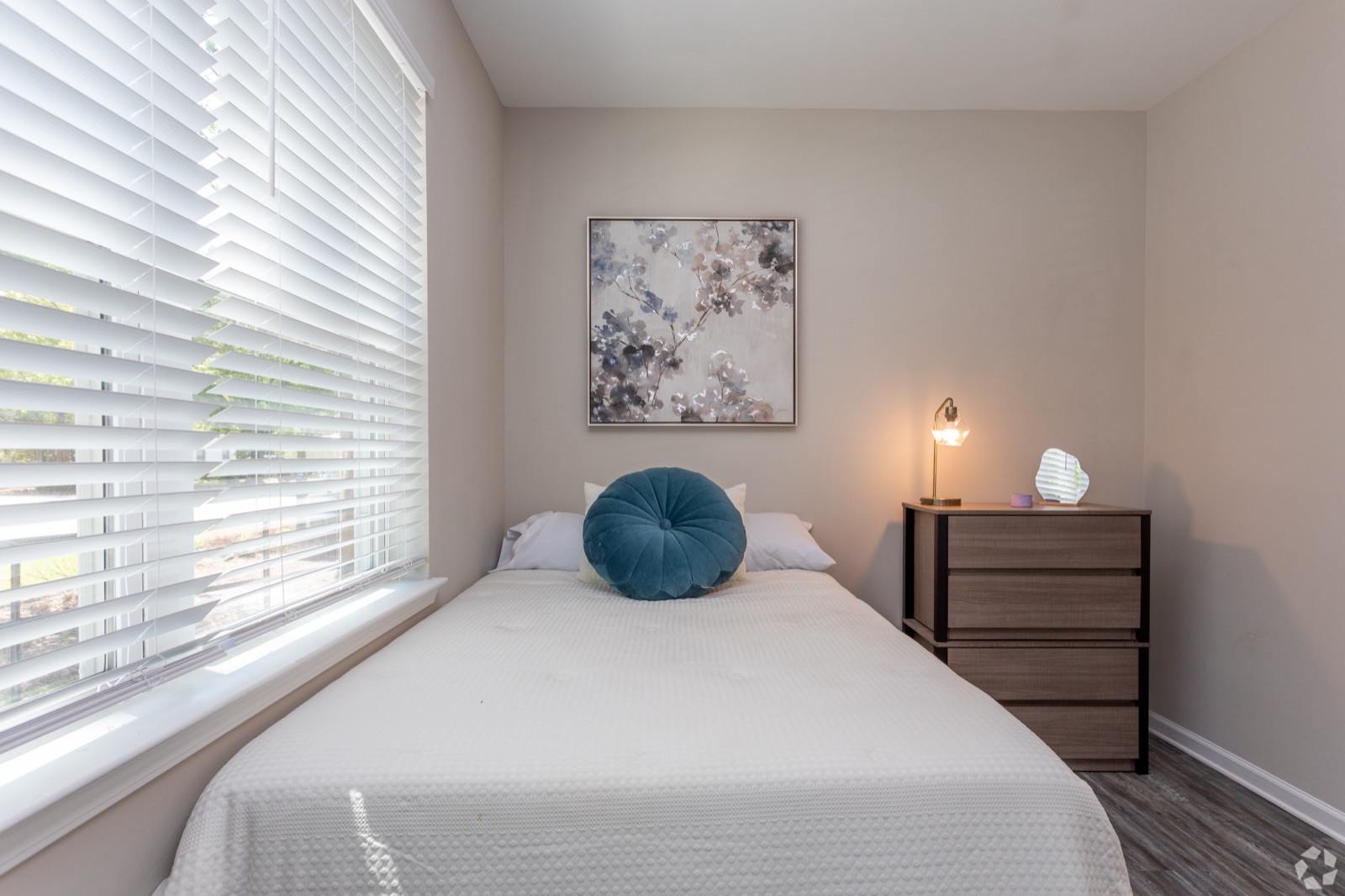 Furnished bedroom with window and dresser