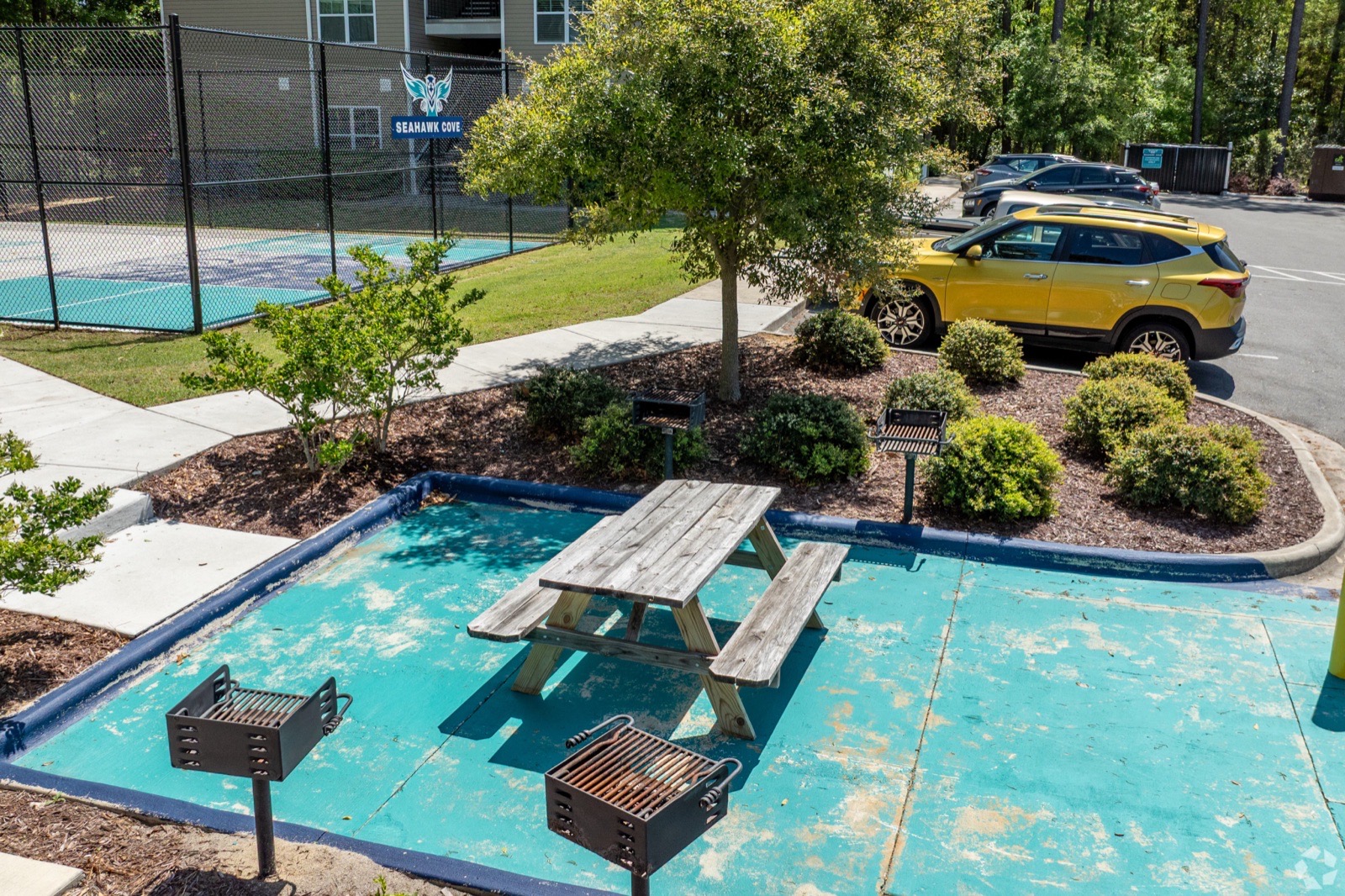 Outdoor grilling and picnic area beside the sport court