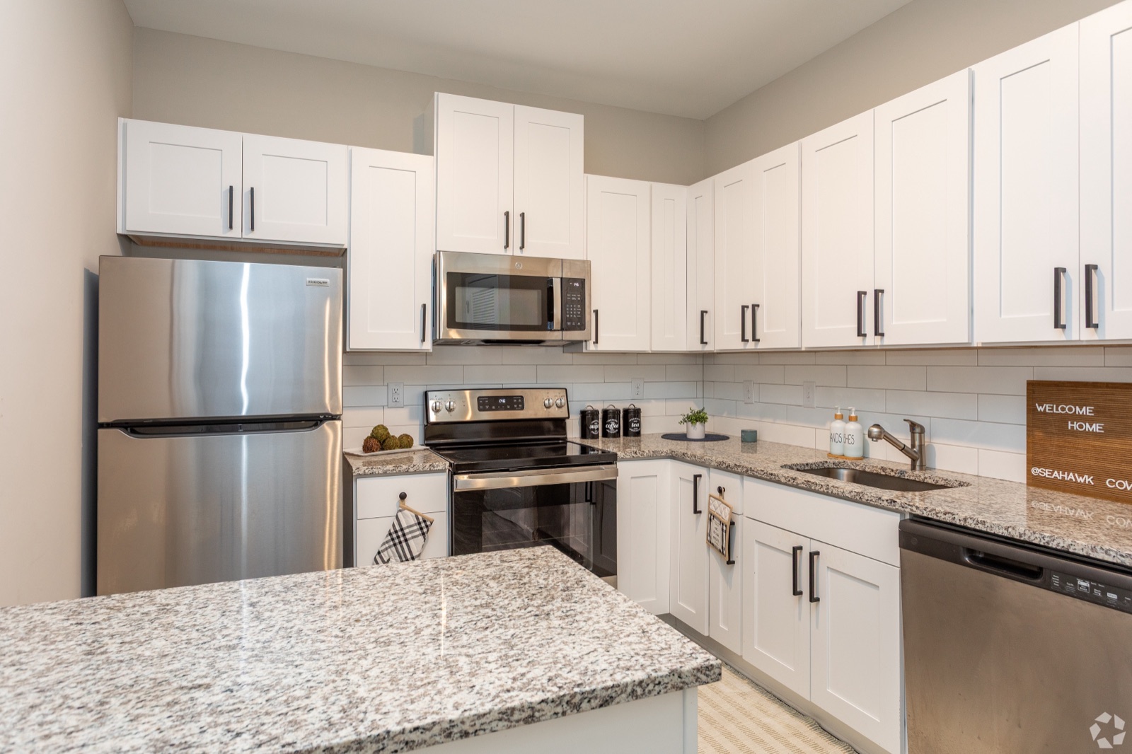 Kitchen with refrigerator and island
