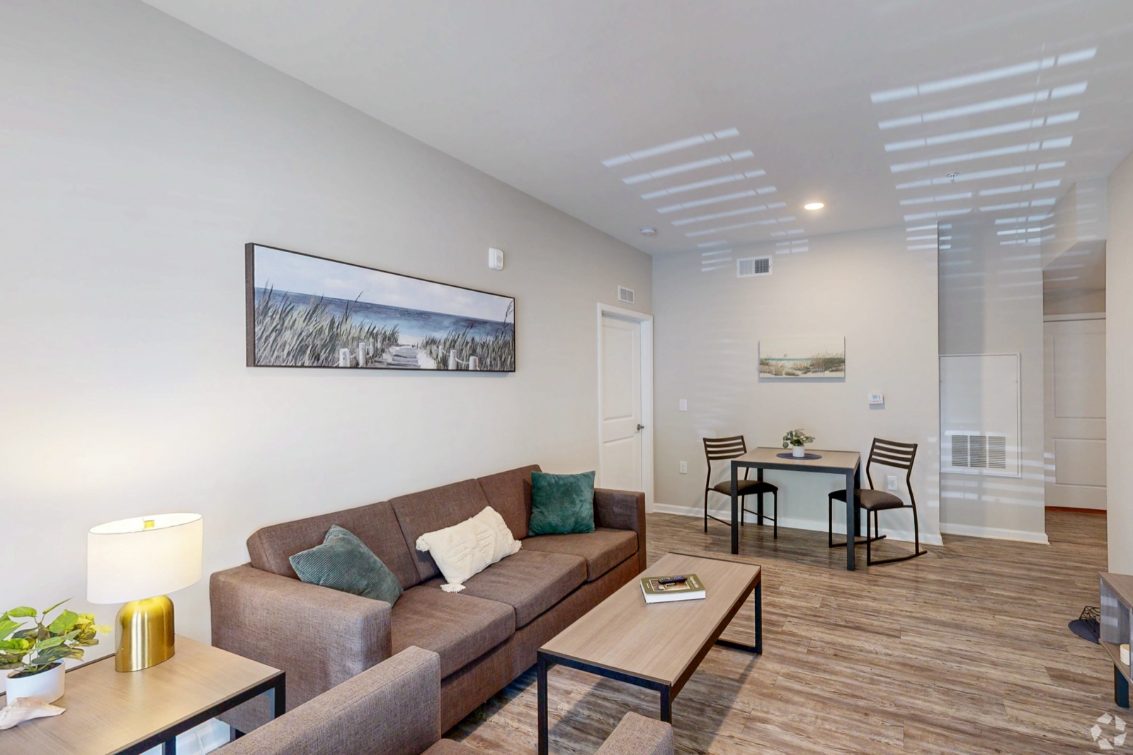 Bright, furnished open-concept living and dining area at Seahawk Cove